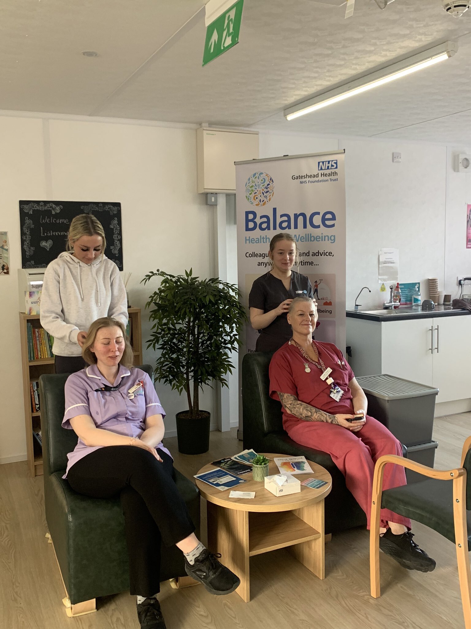 Two Gateshead Health nurses receive Indian Head massages in the Listening Space at the QE Hospital from Gateshead College Botanica Salon students