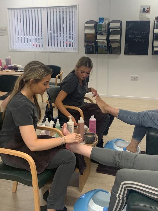 Two Gateshead health colleagues receive pedicures from Gateshead College students