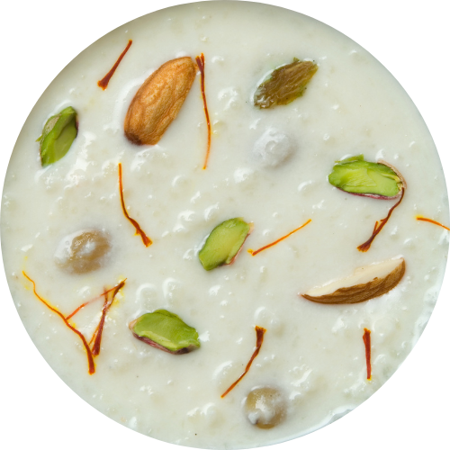 A close up photo of Oats Kheer with mango and pistachios